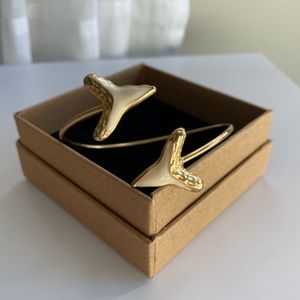 Gold shark tooth bangle.